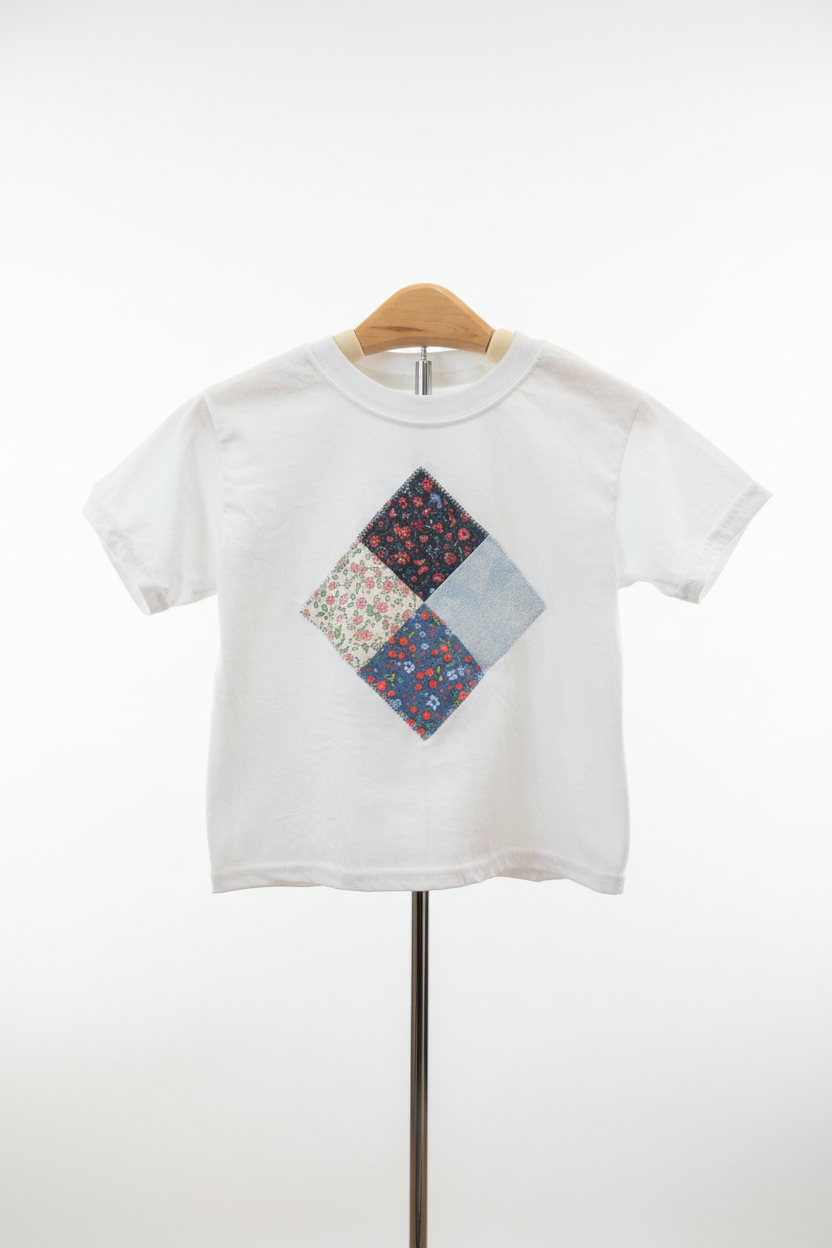 White kids t-shirt with handmade patchwork diamond appliqué on studio white background