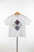 White kids t-shirt with handmade patchwork diamond appliqué on studio white background