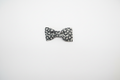 Handmade black and white floral daisy baby hair bow on white studio background