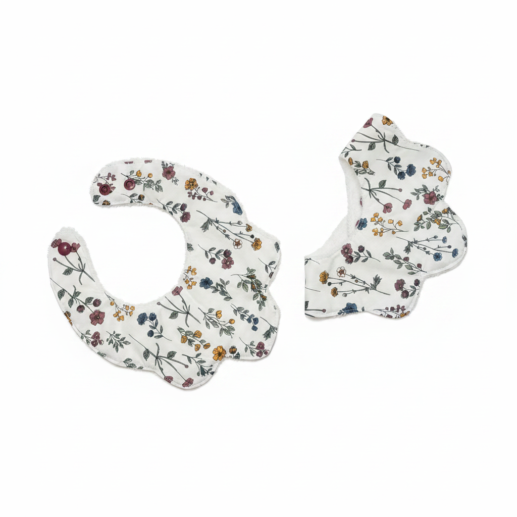 Handmade wildflower print baby bib set on white studio background