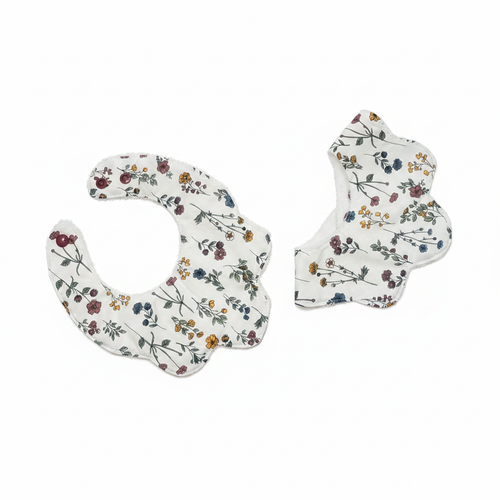Handmade wildflower print baby bib set on white studio background