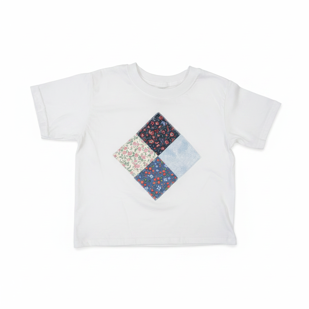 White kids t-shirt with handmade patchwork diamond appliqué flat lay on studio white background