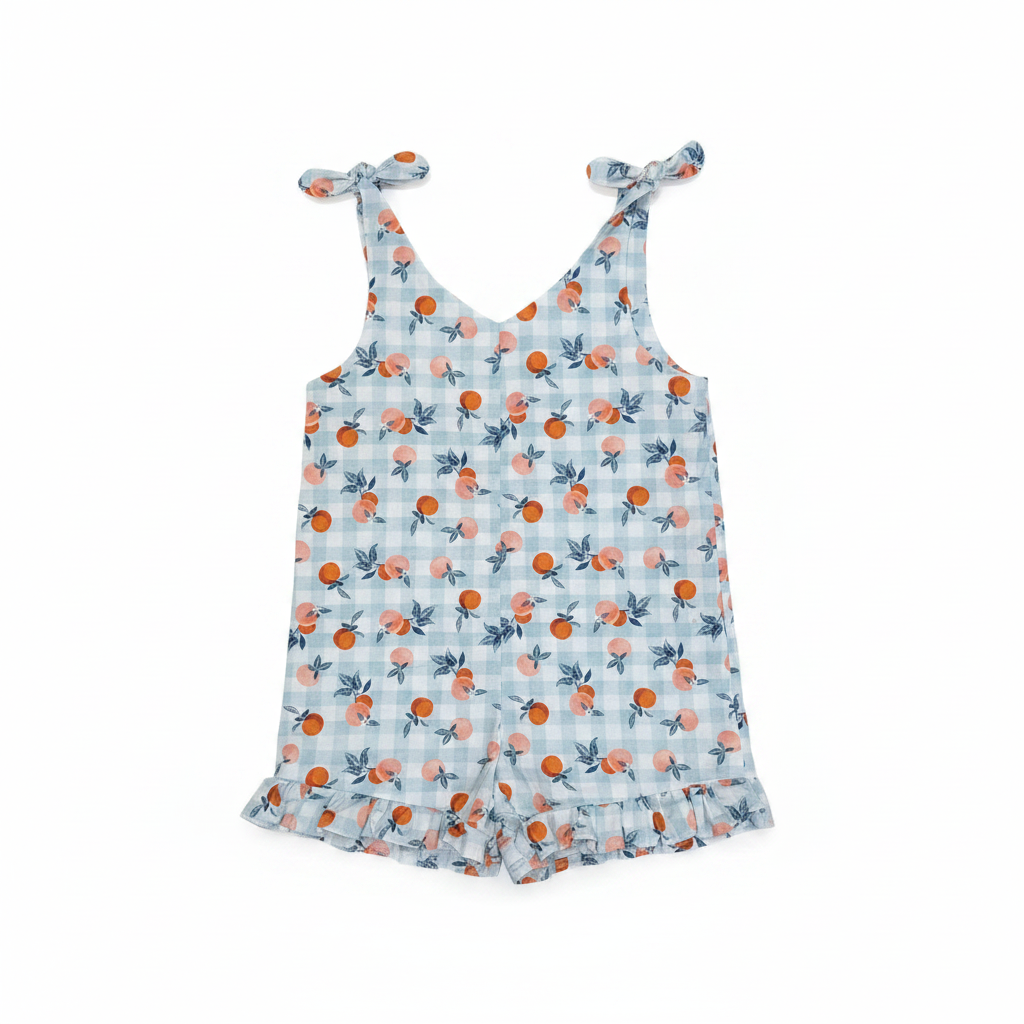 Handmade citrus print toddler romper flat lay on studio white background